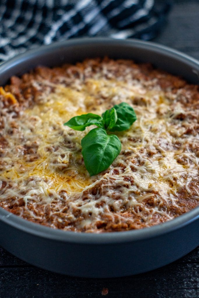 Calling all spaghetti lovers! You're going to love this spaghetti recipe with a twist. Spaghetti Pie has long been one of my family's most go to meals for dinner. Spaghetti pie is a kid-pleasing meal that is simple enough to whip up on a busy weeknight. Essentially, this is a cheesy baked spaghetti that is made in a pie dish or round cake pan.