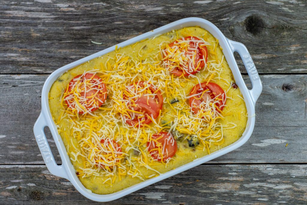 cornbread casserole with tomatoes on top