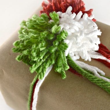 Add a personal touch to your holiday gift giving with diy gift wrap. Learn how to make yarn pom poms to create festive holiday gift wrap.