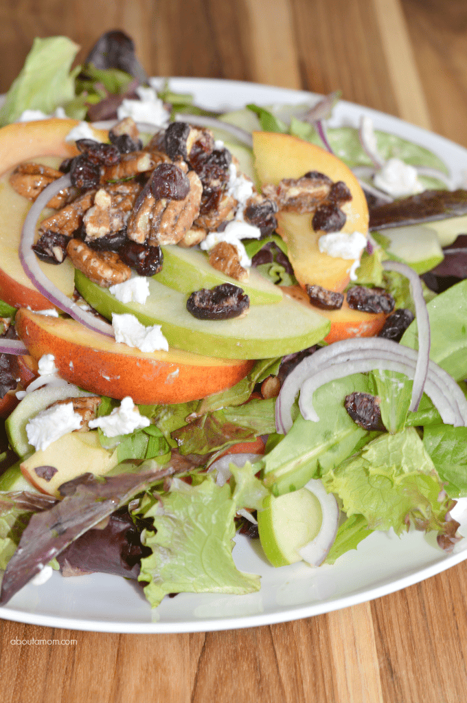 A delicious fruit and nut salad with citrus vinaigrette. Mixed greens, topped with peaches, crisp apple slices, red onion, pecans and goat cheese.