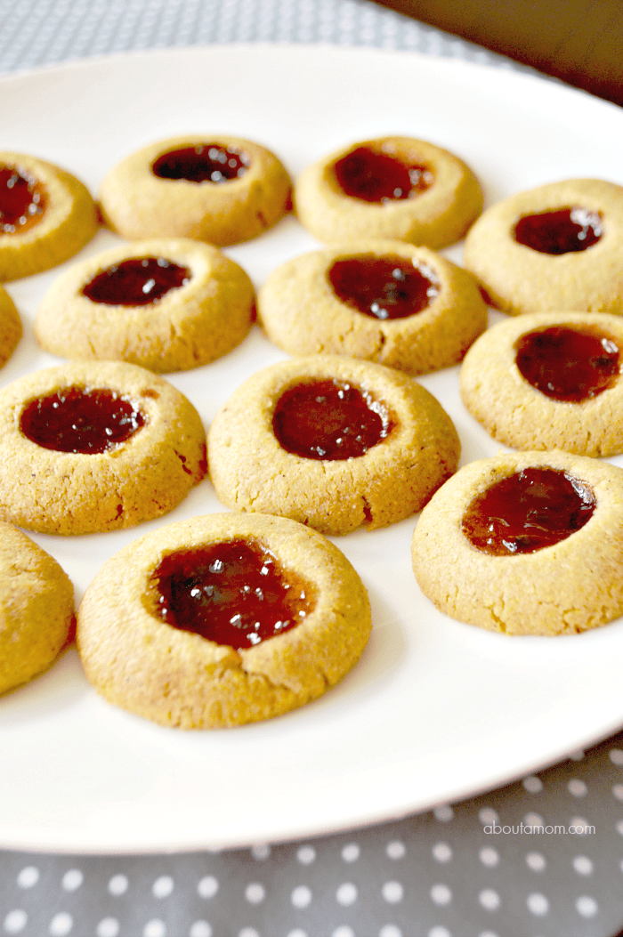 Cornmeal Thumbprint Cookies made with Smucker's Fruit & Honey™ Strawberry Jalapeño Fruit Spread are wonderfully sweet and savory, and a clever twist on the classic jam-filled thumbprint cookie.