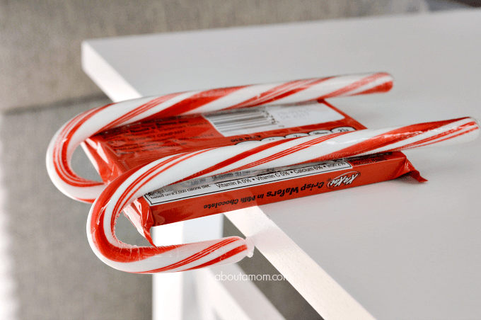 attach 2 candy canes to candy bar such as kit kat