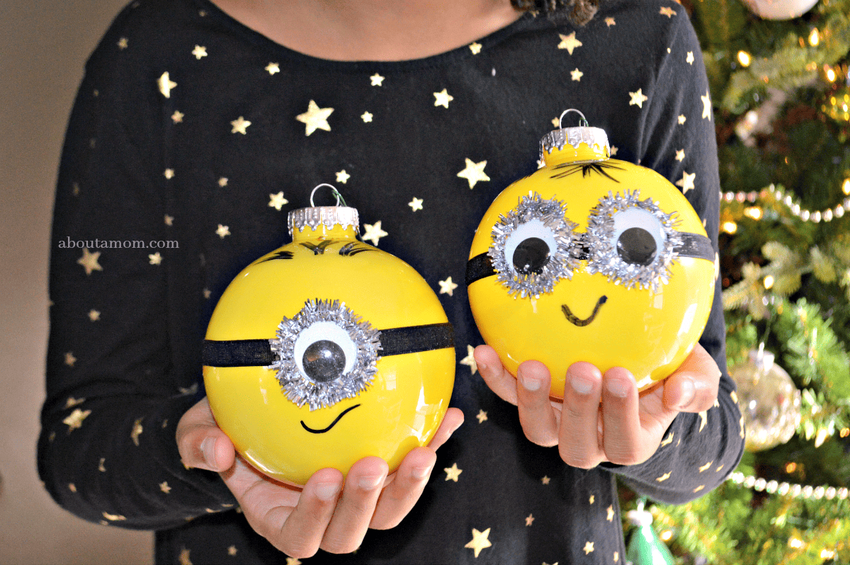 Plastic ball ornaments are used to make these DIY Minion ornaments that are a whole lot of fun and pretty easy to make. A Minion ornament that's perfect for Despicable Me fans young and old alike.