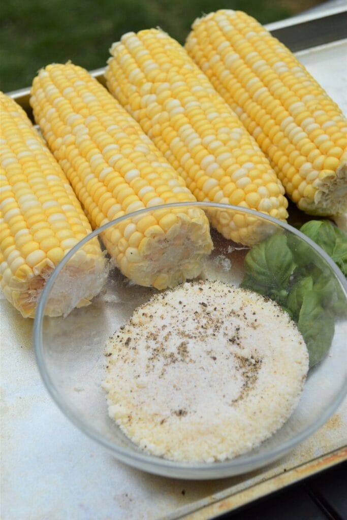 corn and parmesan cheese on a tray