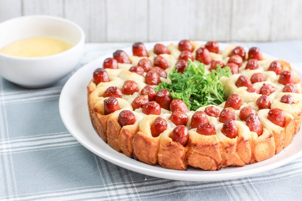 These Pull Apart Pigs in a Blanket are a delicious twist on a classic. Made with pizza dough, these pigs in a blanket are super easy to make. Perfect for a party, get together, game day or a picnic, these appetizers are also a fun dinner idea. This is what I consider FUN food.