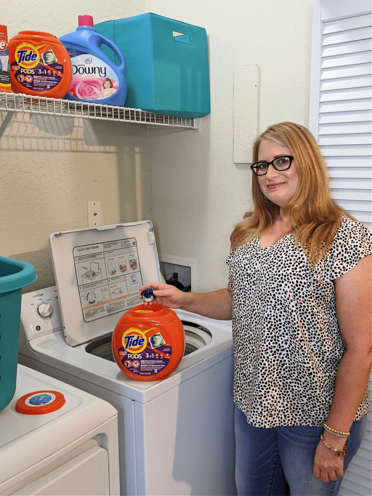 woman doing laundry with Tide, Downy and Bounce