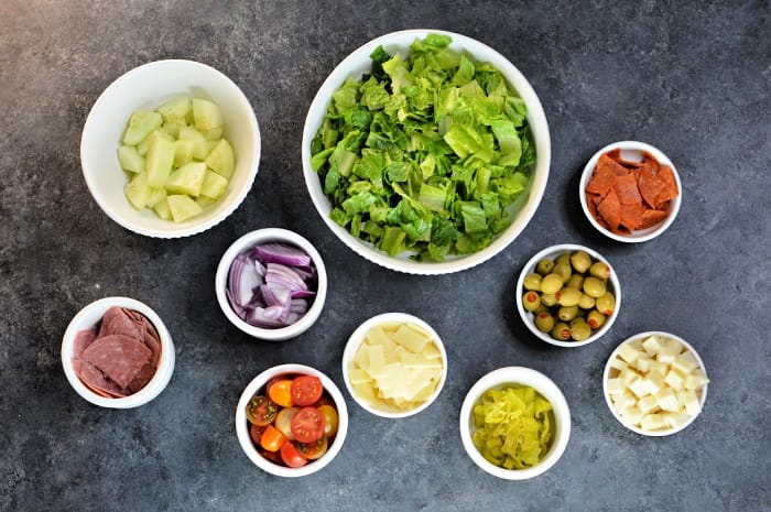 Seriously, this salad rivals any Italian Chopped Salad you could get in a restaurant. This hearty salad is loaded with great flavors and textures. The easy homemade Italian vinaigrette makes this salad addicting. You're family is going to love this one and it perfectly pairs with American Flatbread Pizza!
