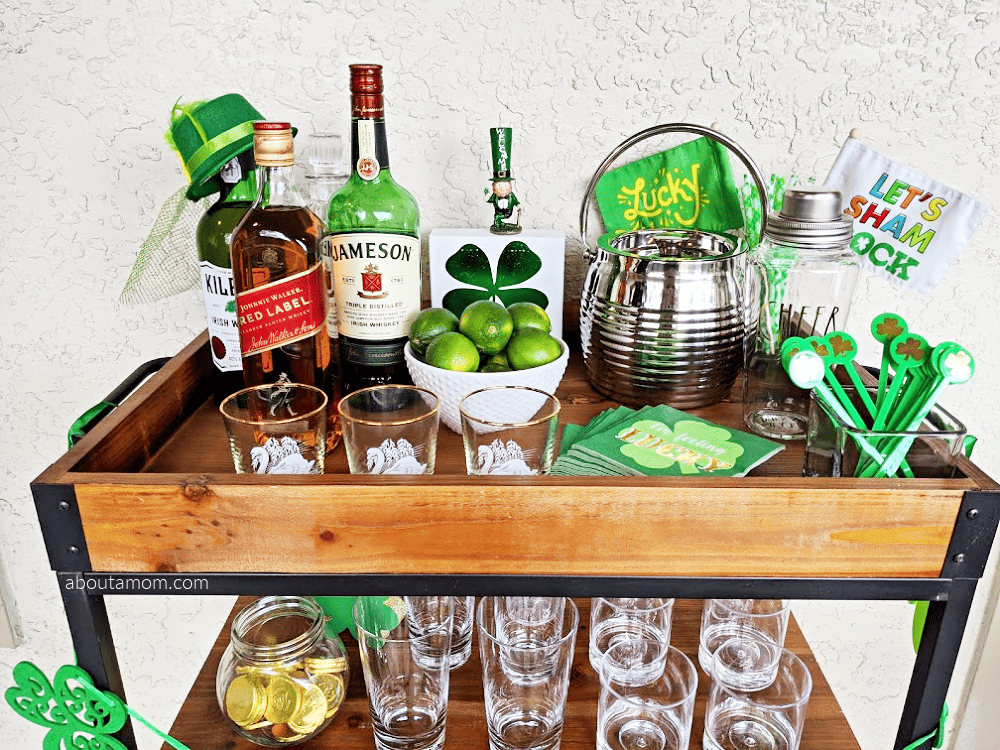 Bar cart styling ideas for St. Patrick's Day. Celebrate March 17th at home in style with this St. Patrick's Day bar cart makeover. See how to style a bar cart for St. Patrick's Day in a way that is fun, simple and won't break the bank. Perfect for a relaxing evening of drinks or Saint Patrick's Day party with family and friends. 