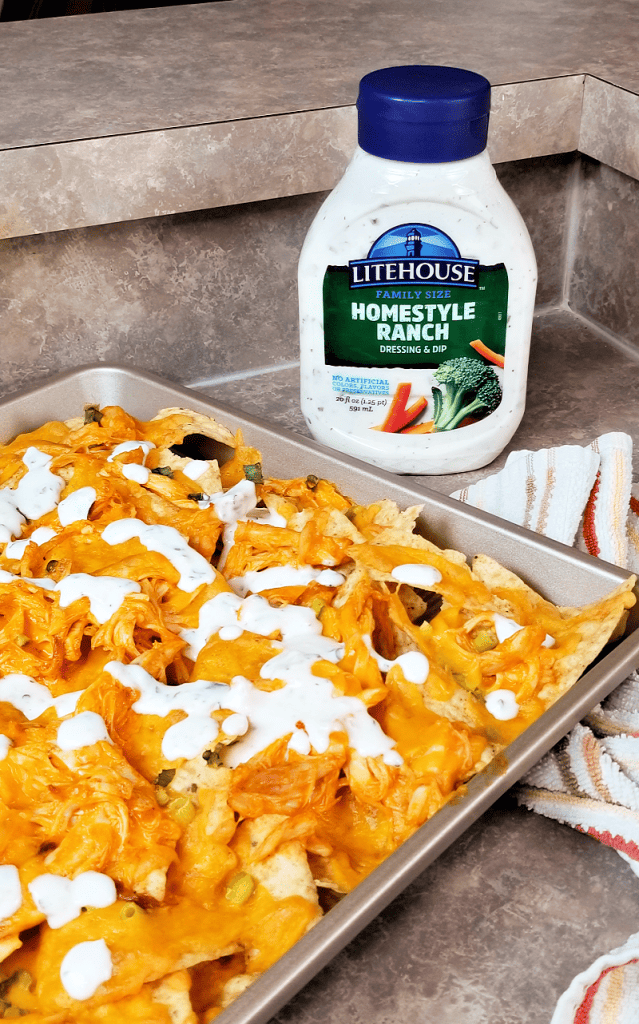 These sheet pan buffalo chicken nachos are cheesy and delicious, and made even better with a generous drizzle of ranch dressing. I live for the weekends and family night and this recipe for buffalo ranch chicken nachos is ideal for a laid-back family movie night or game night. Make these nachos for game day too!
