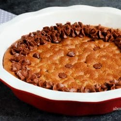 It doesn't get much better or easier than a soft and chewy chocolate chip cookie that is baked in a pie dish. Decorate this giant chocolate chip cookie pie with chocolate frosting, then slice and serve warm with a scoop of vanilla ice cream and a chocolate drizzle. Mmmm.