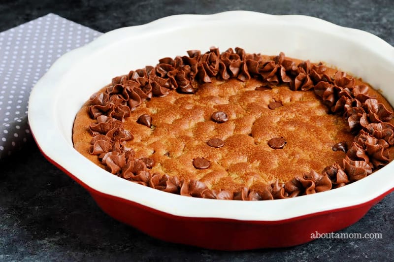 It doesn't get much better or easier than a soft and chewy chocolate chip cookie that is baked in a pie dish. Decorate this giant chocolate chip cookie pie with chocolate frosting, then slice and serve warm with a scoop of vanilla ice cream and a chocolate drizzle. Mmmm.