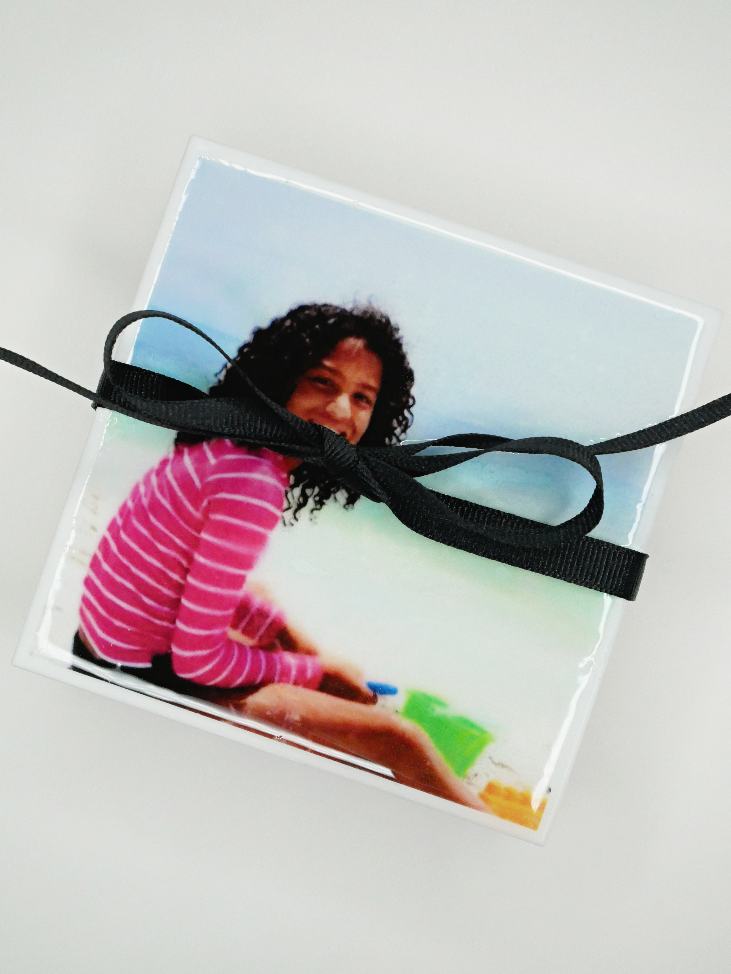 Learn how to make photo coasters. These DIY Photo Coasters are incredibly simple and inexpensive to make, and a fun project that will bring your photos to life. Everyone will love these personalized photo gifts.