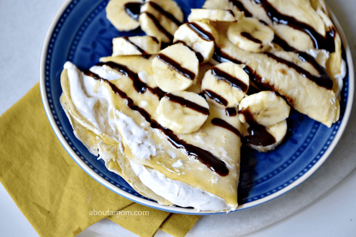 Treat yourself to some banana split crepes. Delicate crepes with a sweet cream filling, bananas and chocolate.