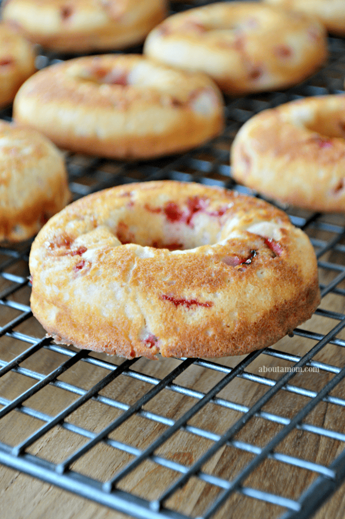 Baked Strawberry Donuts with Strawberry Glaze are made fun and extra delicious with a colorful Fruity Pebbles topping. 