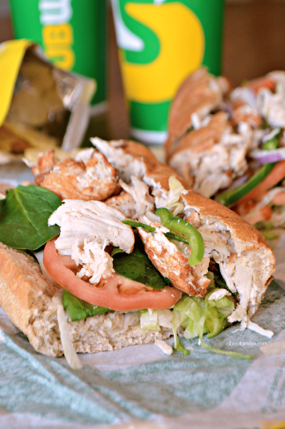 A delicious rotisserie-style chicken sandwich, made with tender, hand-pulled all white meat chicken, raised without antibiotics, and topped with flavorful crisp veggies on freshly baked bread.