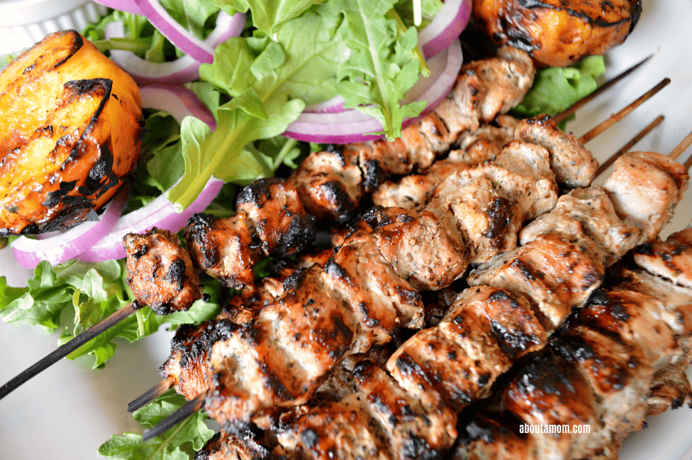 Delicious marinated grilled pork skewers served with grilled peaches, arugula and a refreshing cucumber mint sauce.