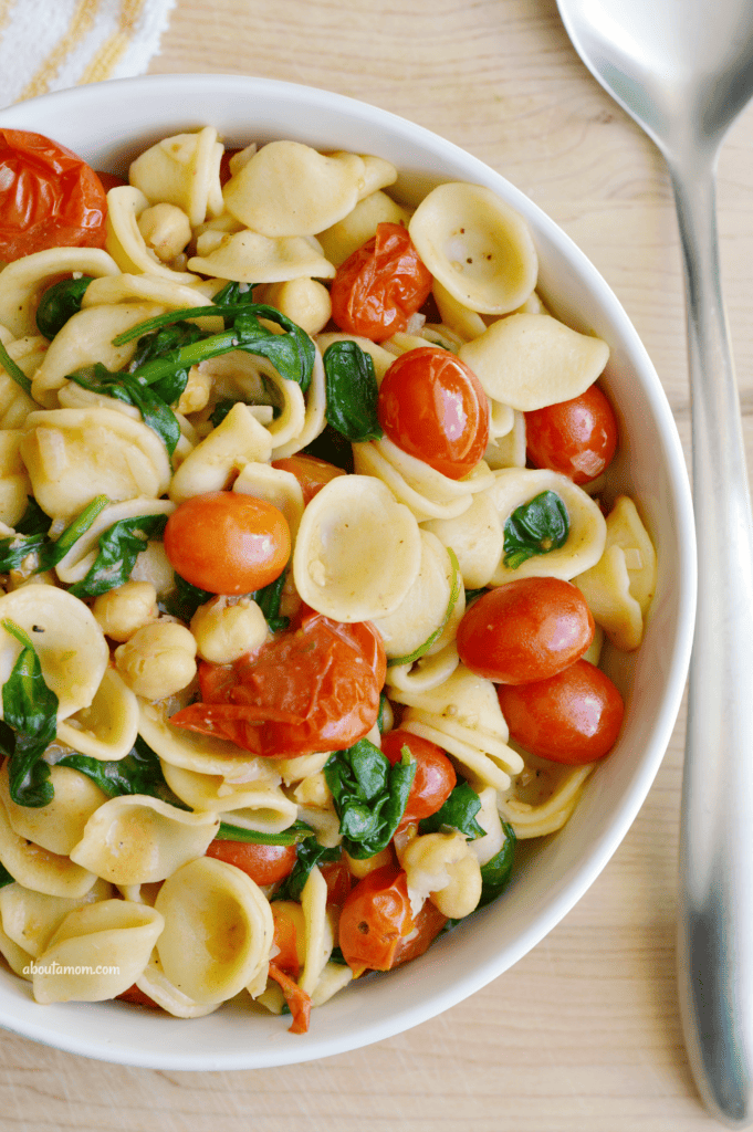 A delicious and easy-to-prepare orecchiette pasta recipe. Orecchiette pasta with sauteed tomatoes, spinach and white beans is a simple yet flavorful dish inspired by my travels across Italy last summer.