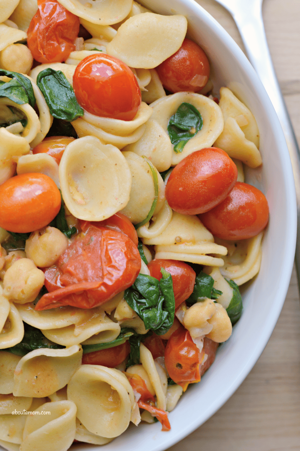A delicious and easy-to-prepare orecchiette pasta recipe. Orecchiette pasta with sauteed tomatoes, spinach and white beans is a simple yet flavorful dish inspired by my travels across Italy last summer.