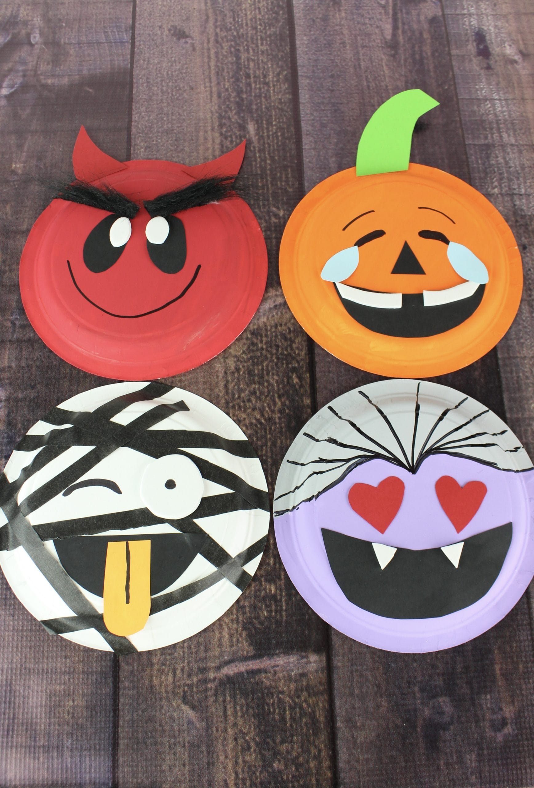 Halloween craft for kids. Instructions for 4 separate emoji Halloween paper plate crafts. Includes a pumpkin, vampire, mummy and devil.