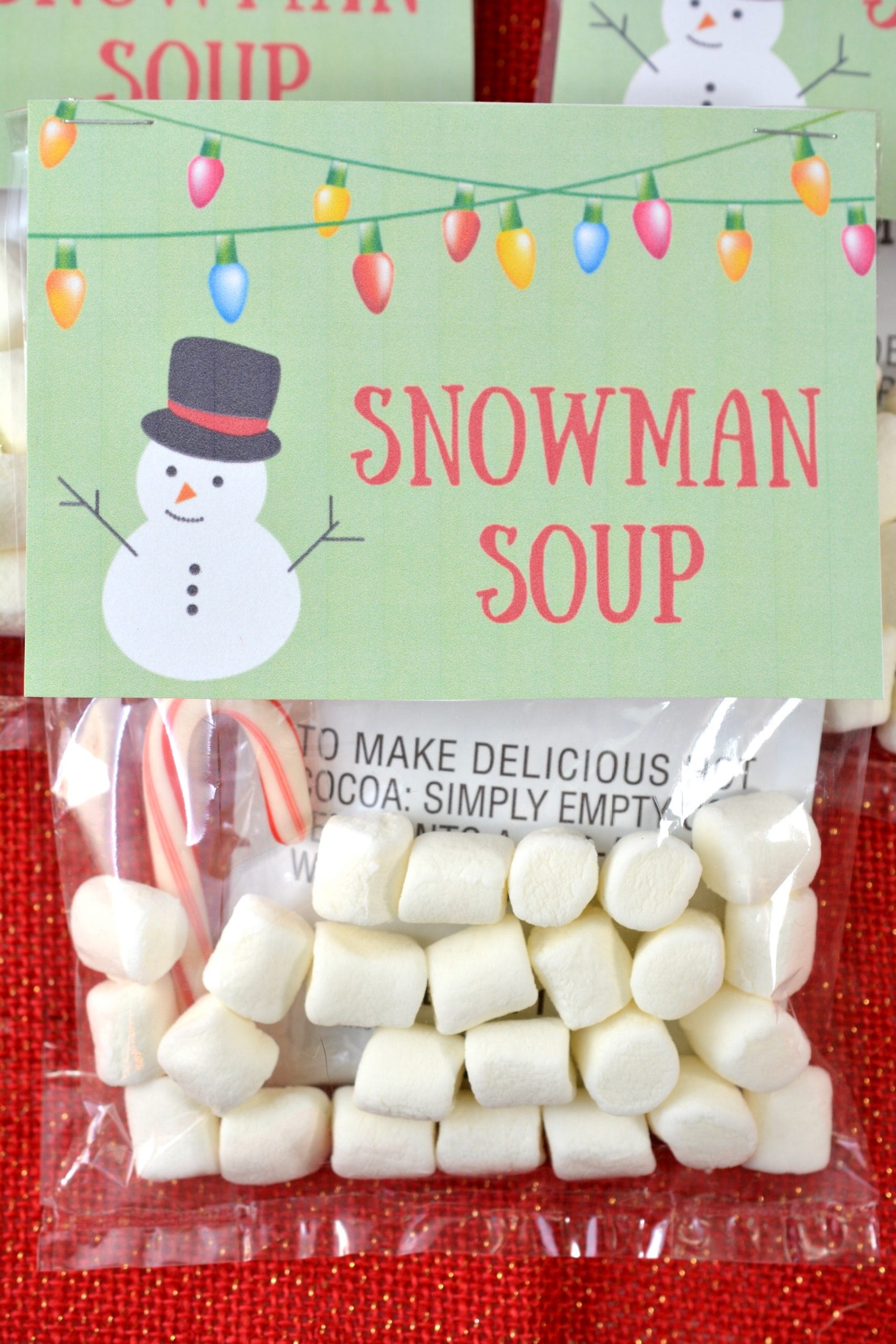 Snowman Soup is a simple homemade Christmas gift idea. With this printable snowman soup tag, you simple place 3 ingredients in the bag and staple the free printable over the bag. Christmas printables like this make holiday gift giving simple and affordable.