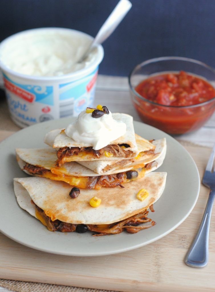 These Pulled Pork Quesadillas are a mouthwatering lunch or dinner idea. Easy to make, these quesadillas start off in the slow cooker or Instant Pot. This dish is also a great way to use leftover pulled pork.