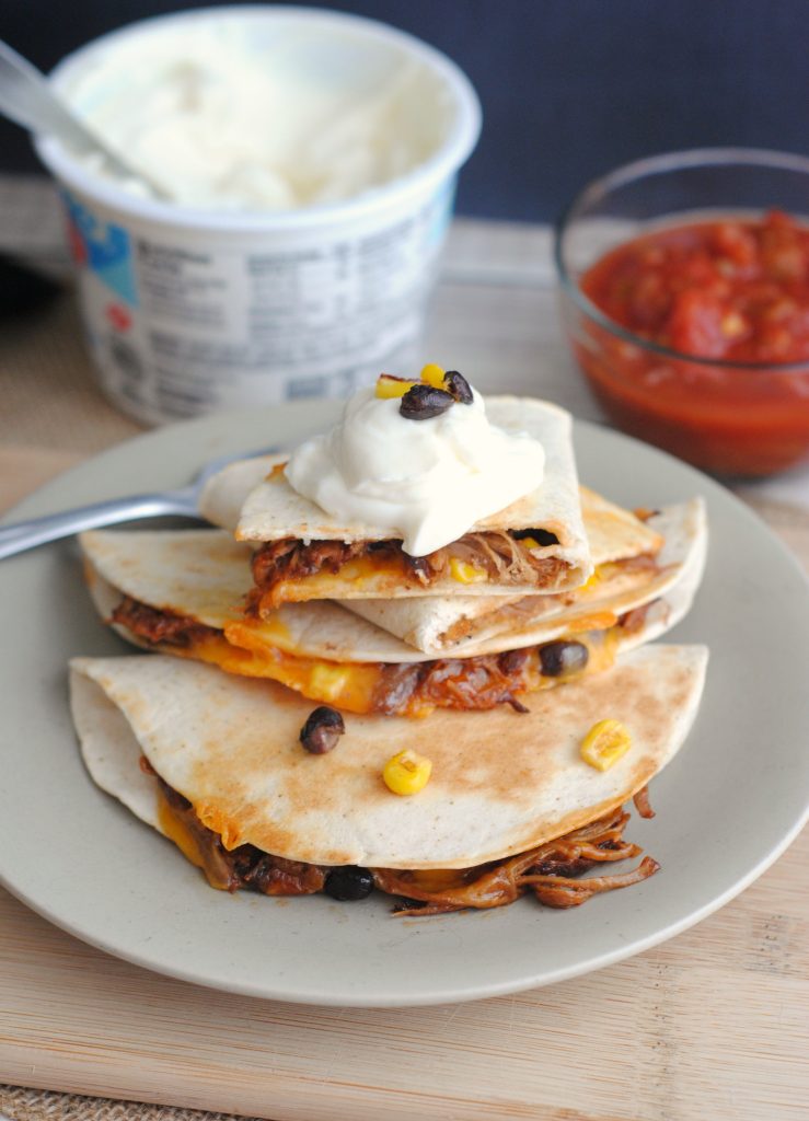 These Pulled Pork Quesadillas are a mouthwatering lunch or dinner idea. Easy to make, these quesadillas start off in the slow cooker or Instant Pot. This dish is also a great way to use leftover pulled pork.