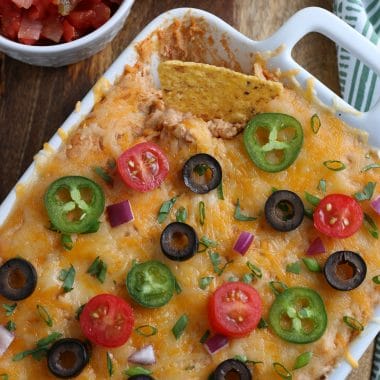 This Easy Bean Dip is one of my favorite game day recipes to make. Perfect for parties and special occasions, this bean dip is tasty and inexpensive and is always a hit. Serve it for a simple appetizer or make it when having festive Mexican night.