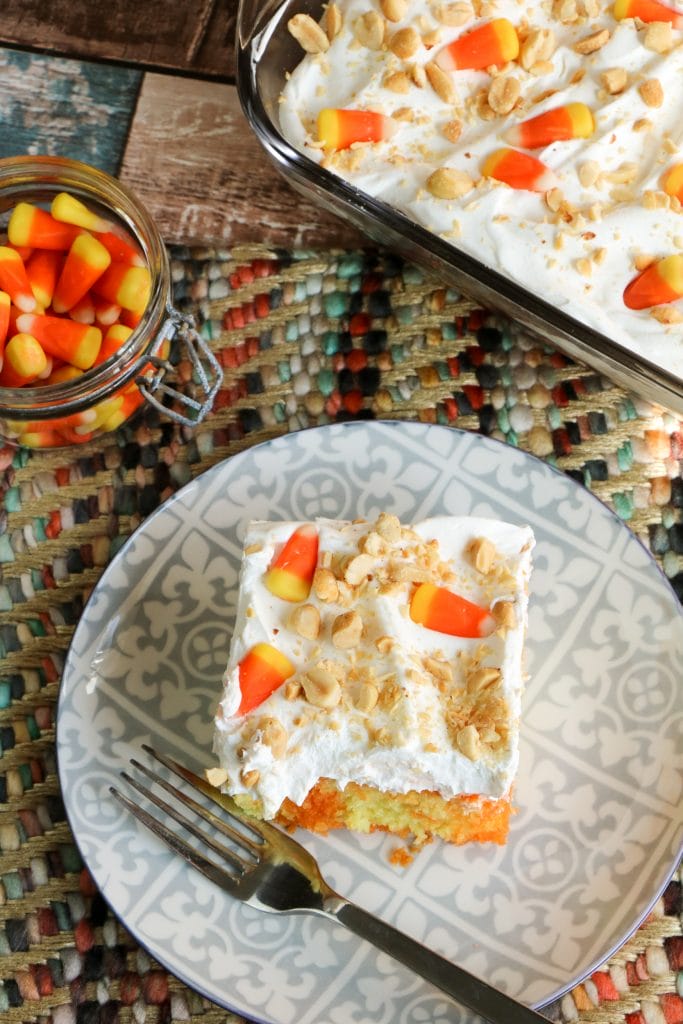 Do you like candy corn? I'm totally on Team Candy Corn! Even if you just like it a little, I think you are going to absolutely love this easy-to-make Candy Corn Poke Cake. I happen to be a huge fan of both candy corn and poke cakes so this Halloween dessert is totally for me. A delicious moist cake that not only is delicious involves candy corn. This festive poke cake recipe is perfect for the Halloween and Fall season.