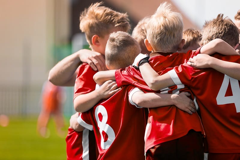Kids Play Sports Game. Children Sporty Team United Ready to Play Game. Children Team Sport. Youth Sports For Children. Boys in Sports Jersey Red Shirts. Young Boys in Soccer Sportswear