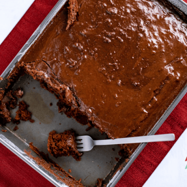 This cherry chocolate cake is so simple to make but is decadent enough for special occasions. A moist chocolate cake mix and a can of cherry pie filling come together for a fudgy and delicious dessert. The fudge frosting puts this sheet cake over the top!
