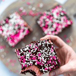 Fudgy brownies with a pretty pink frosting and a chocolate ganache are topped with pretty Valentine's Day sprinkles. This decadent Valentine's Day treat is a great way to say "I love you." Sweetheart Brownies is such a sweet and easy Valentine's Day dessert.