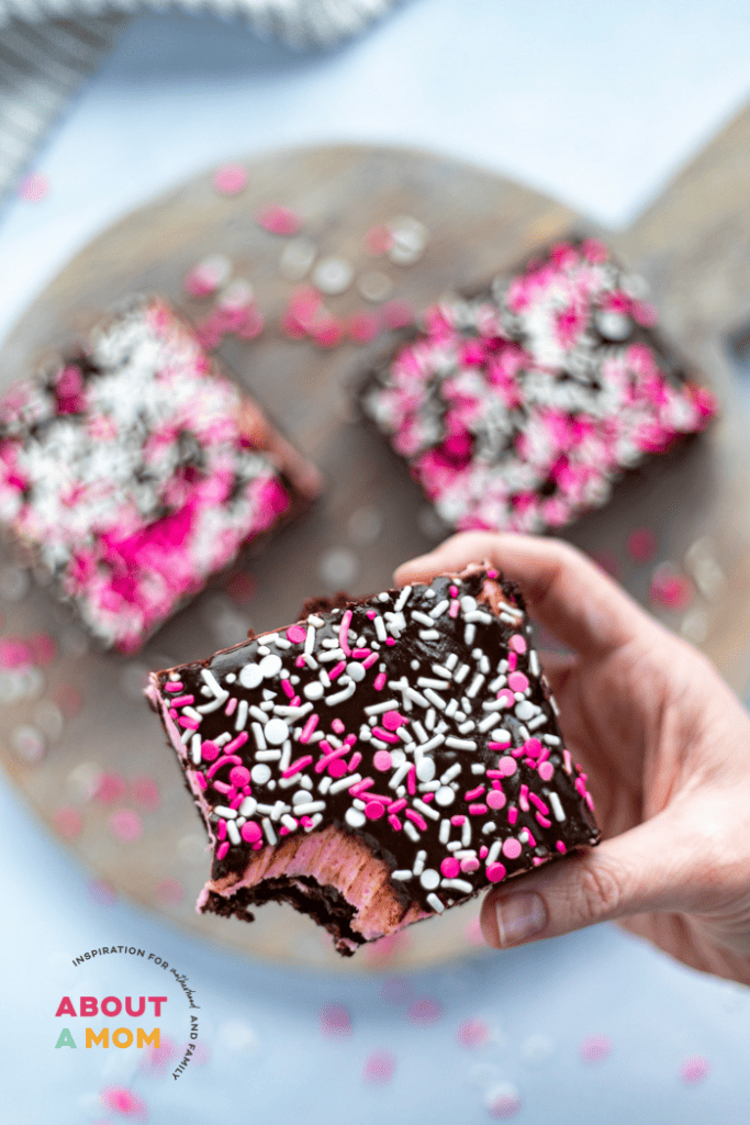 Fudgy brownies with a pretty pink frosting and a chocolate ganache are topped with pretty Valentine's Day sprinkles. A decadent Valentine's Day treat that says "I love you." This Sweetheart Brownies recipe is such a sweet and easy Valentine's Day dessert.
