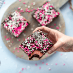 Fudgy brownies with a pretty pink frosting and a chocolate ganache are topped with pretty Valentine's Day sprinkles. This decadent Valentine's Day treat is a great way to say "I love you." Sweetheart Brownies is such a sweet and easy Valentine's Day dessert.