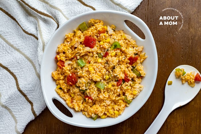 This is the best easy cheesy Mexican rice recipe. It is a restaurant-style Spanish rice recipe that comes together in no time. Serve this flavorful Mexican side dish with your favorite enchiladas or chimichangas. It is the perfect side for Taco Tuesday!