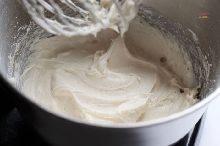 cream cheese frosting in a bowl with a mixer