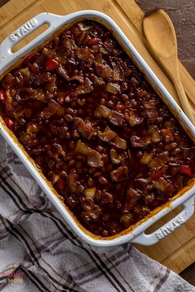 This is simply the best smokey baked beans recipe! This side dish comes together easily with canned beans, peppers, onions, molasses, brown sugar, a few dashes of liquid smoke and some additional pantry staples.