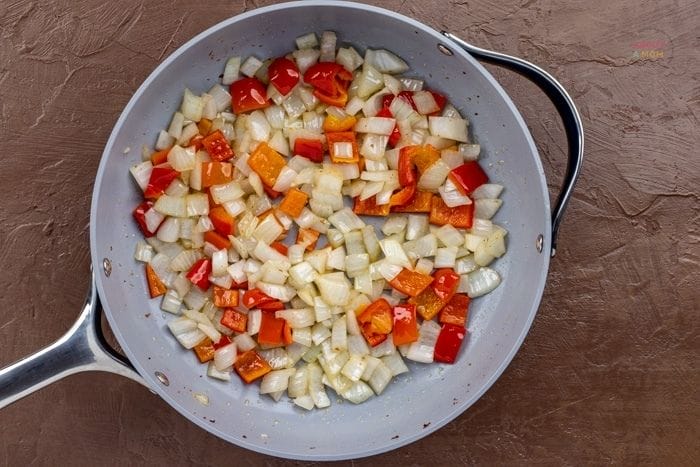 peppers and onions in a frying pan