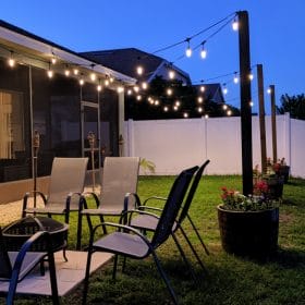 Have you wondered to to hang outdoor string lights? Make whiskey barrel planters with built-In posts for string lights. Add ambiance to your backyard with this step-by-step tutorial for a DIY planter with pole for string lights.