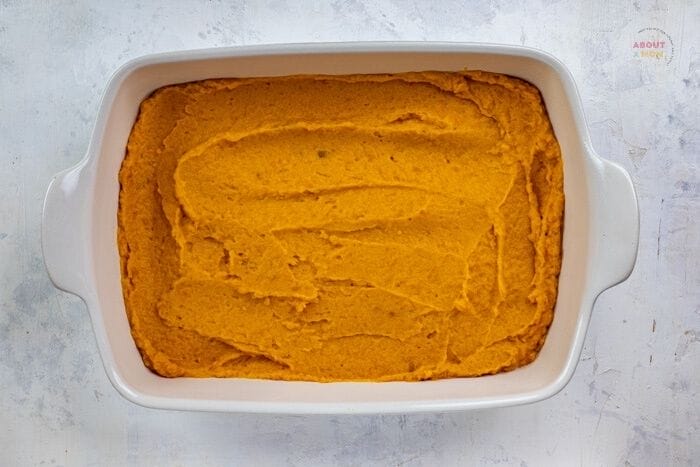 mashed sweet potatoes spread into bottom of casserole dish