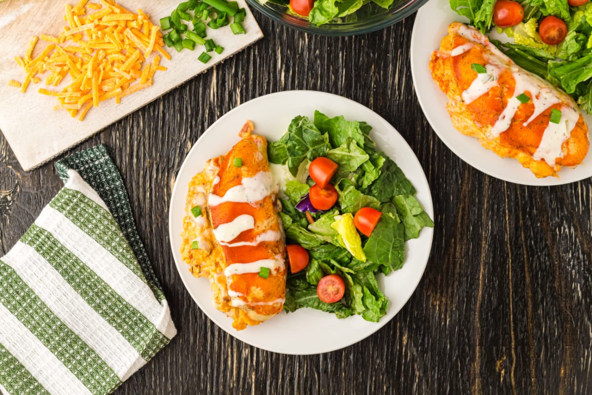 This is a Buffalo chicken recipe like no other. We've taken all the deliciousness of buffalo chicken and stuffed it inside a chicken breast for a meal that will rock your world. Buffalo Stuffed chicken is tender, juicy chicken smothered in buffalo sauce and cheese.