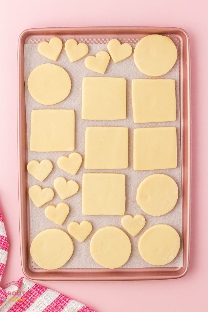 cookie cut outs on a baking sheet