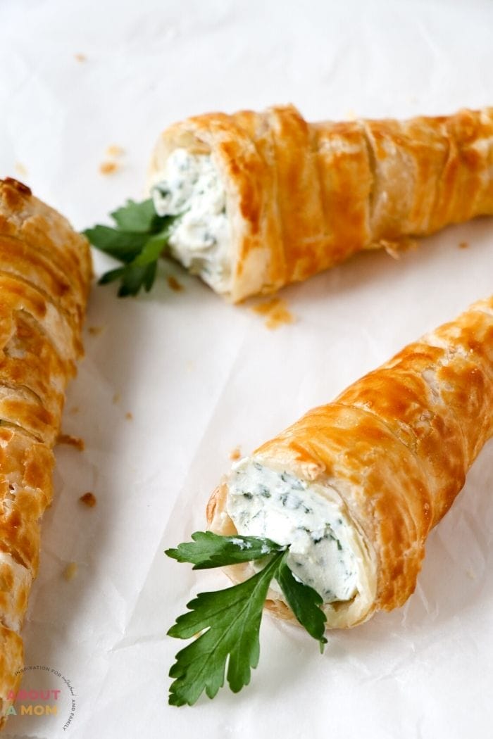 These Cream Cheese Filled Puff Pastry Carrots are the perfect way to celebrate Easter!  They're made with herbed cream cheese and puff pastry, so they're delicious and fun.  Serve this as an Easter appetizer or in the place of dinner rolls or biscuits.