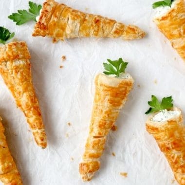 These Cream Cheese Filled Puff Pastry Carrots are the perfect way to celebrate Easter! They're made with herbed cream cheese and puff pastry, so they're delicious and fun. Serve this as an Easter appetizer or in the place of dinner rolls or biscuits.