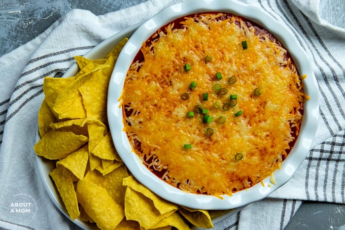 4 layer bean dip made with cream cheese, chili beans, salsa and shredded cheese